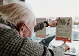 Volunteer Champion John putting up posters in his local area