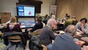 North of Tyne Volunteering Event Large group of people in a room watching a presentation.