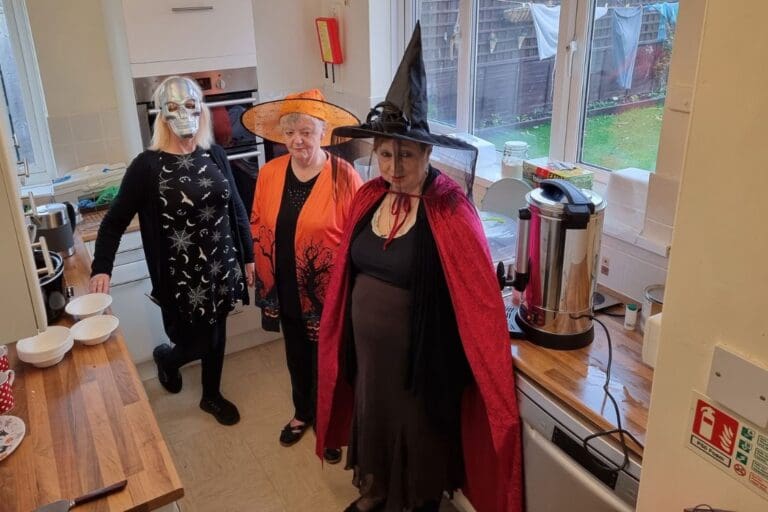 3 women in halloween fancy dress standing in kitchen with the new equipment.