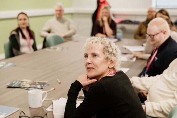 People sat round table at meeting